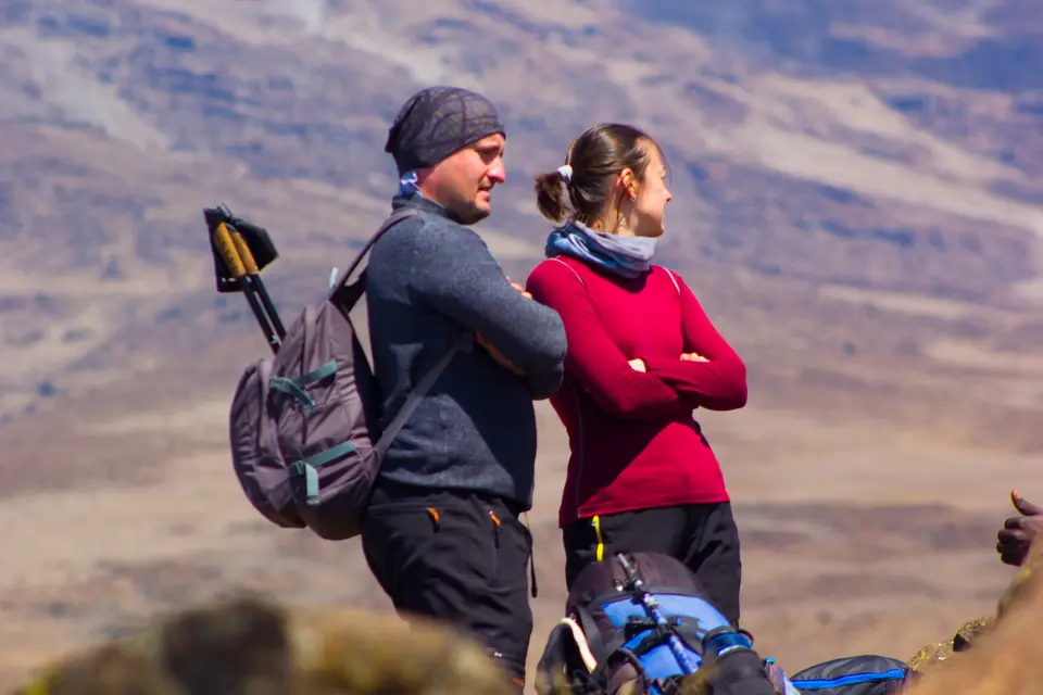 Hikers trekking on Mount Kilimanjaro with a cost breakdown