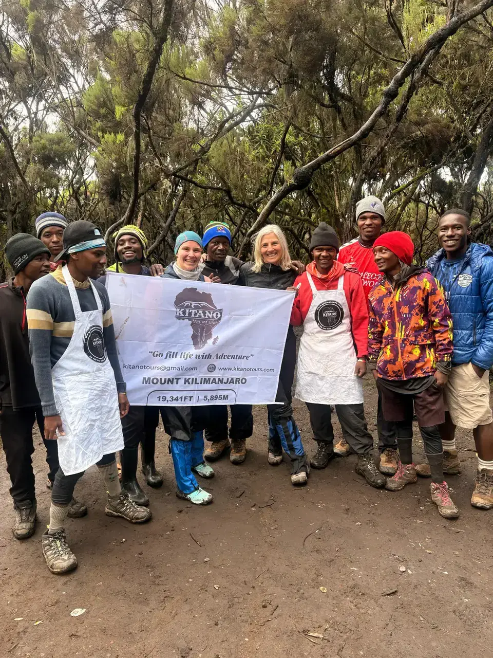 Kitano Tours Kilimanjaro mountain crew holding the company banner